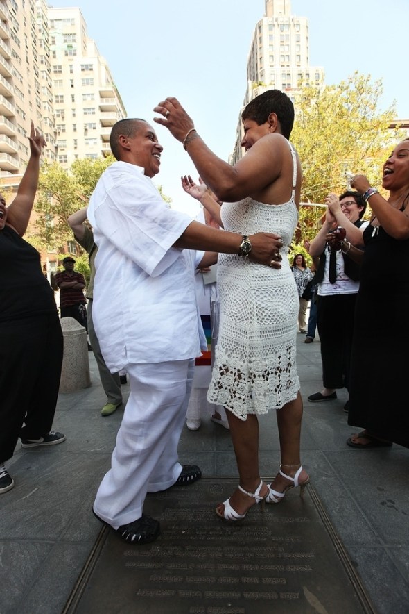 ZP_Two women celebrate with friends and relatives after their outdoor marriage in Washington Square Park , New York City.