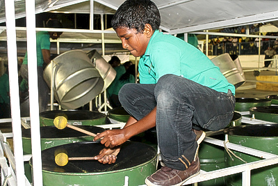 ZP_A 12 year old boy and member of the Tamana Pioneers steel orchestra practises his bass drums_ Arima, Trinidad_ January 2013