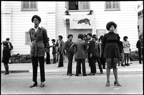 Glen Wheeler and Claudia Grayson, known as Sister Sheeba, stand outside George Jackson's funeral at St. Augustine's Church in Oakland, California_August 1971