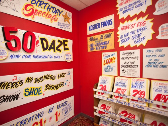 Some of Honest Ed's iconic handpainted signs on display in 2012_Wayne Reuben has been, for decades, that man with the calligraphy brush and the poster paints.