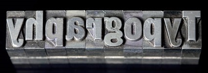 Old fashioned metal typesetters' blocks_These tools were used by the print and publishing trades before the advent of the computer era_The Concrete Poetry movement relied on such standard building blocks for its words-as-objects format.