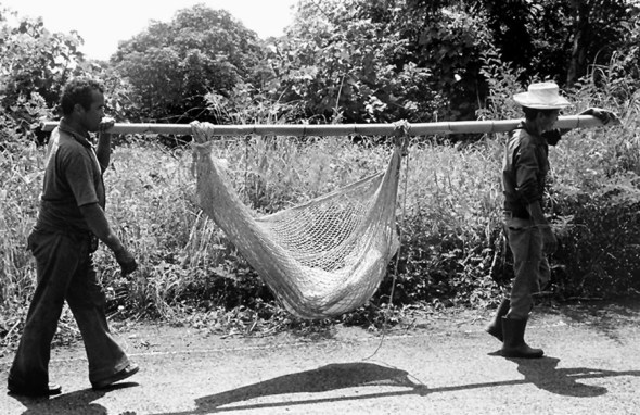 Gary Mark Smith_1982 photograph of a victim of the civil war in El Salvador being carried home for burial_wrapped up in a hammock